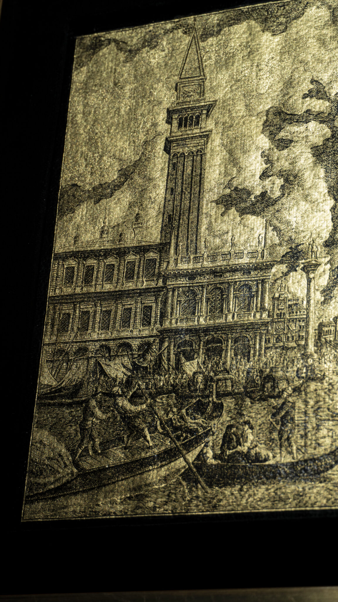 Detail of the artwork “An Icon of Venice”: St Mark’s Campanile, the monumental façade and boats on the basin engraved on gold leaf.