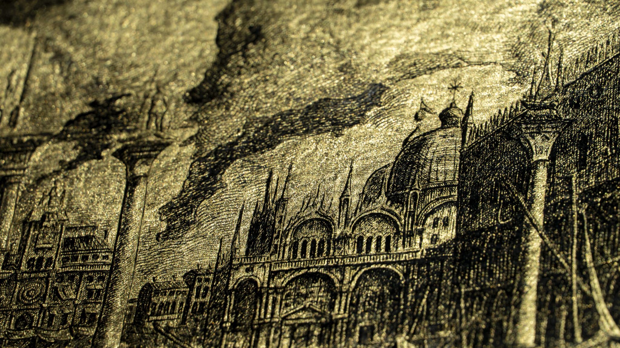 Detail of the artwork “An Icon of Venice”: St Mark’s Basilica and the columns of the Piazzetta engraved on gold leaf, with dark clouds in the background.